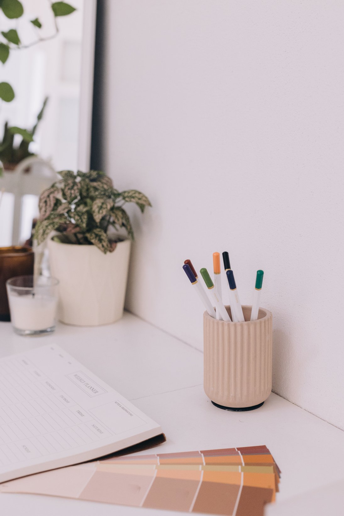 Notebook, Color Palettes, and Pens on a Desk